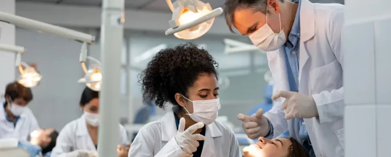 medical instructor observes his medical student as she undergo intensive training about human anatomy