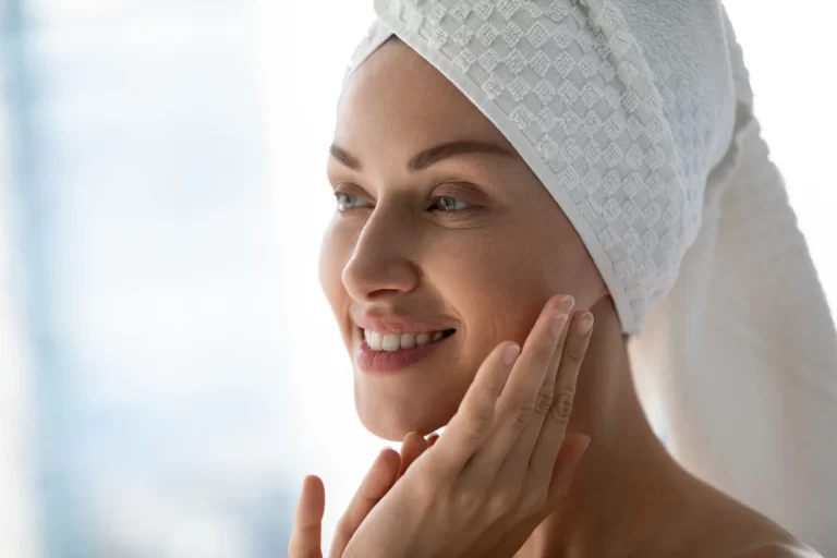 a woman touches her face after bath